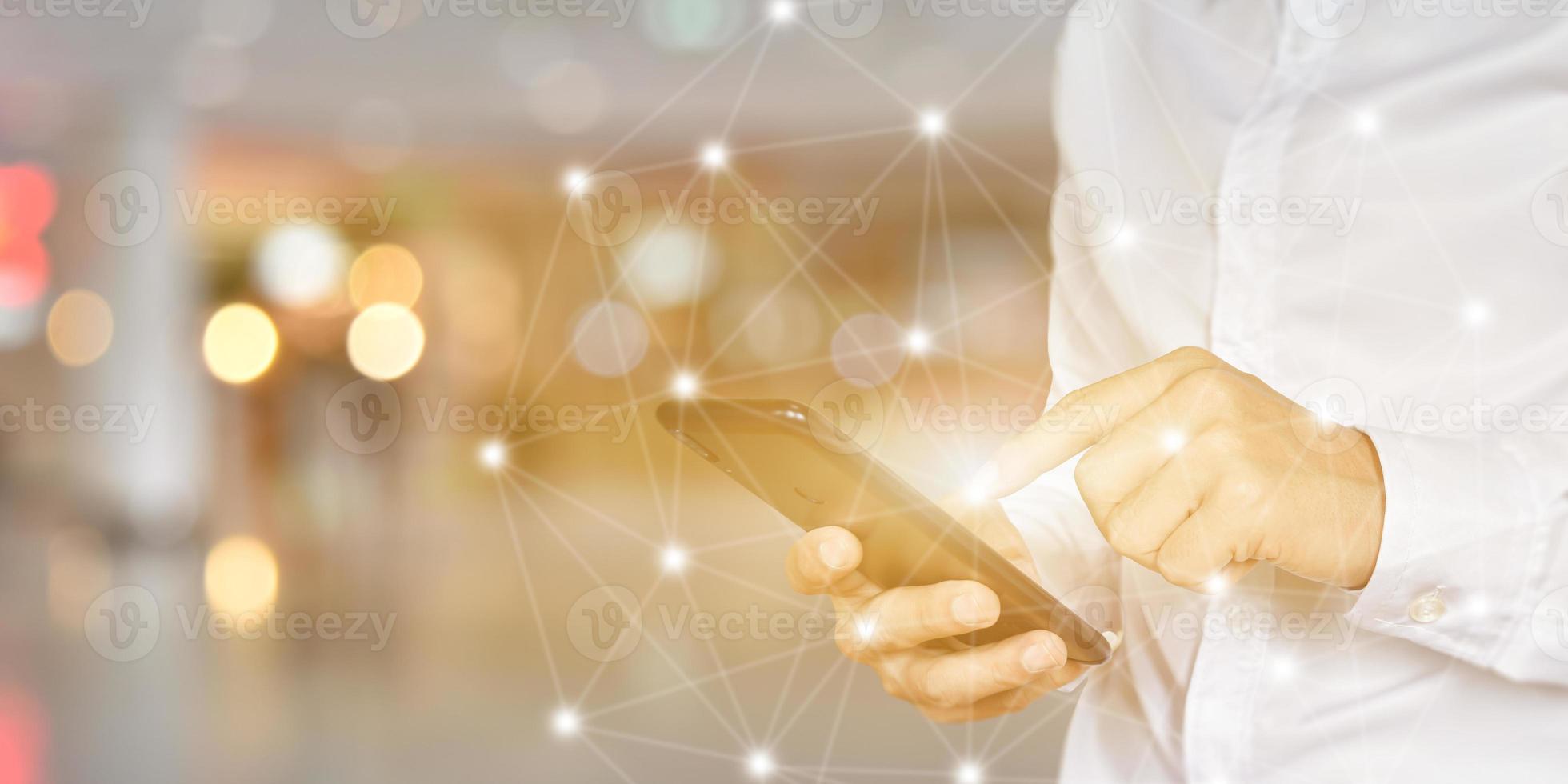 Close up of Businessman using smartphone with icon network. Man hand holding mobile phone for technology or internet banking concept. photo