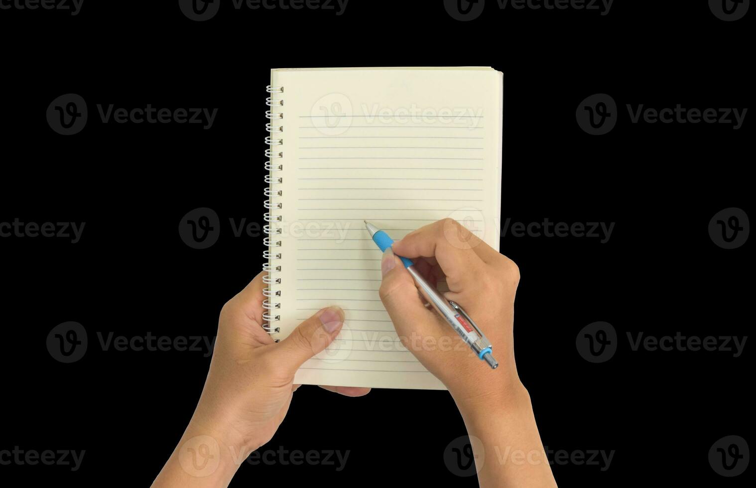 Hand holding pen, with a blank notes over blackboard background. Design concept photo