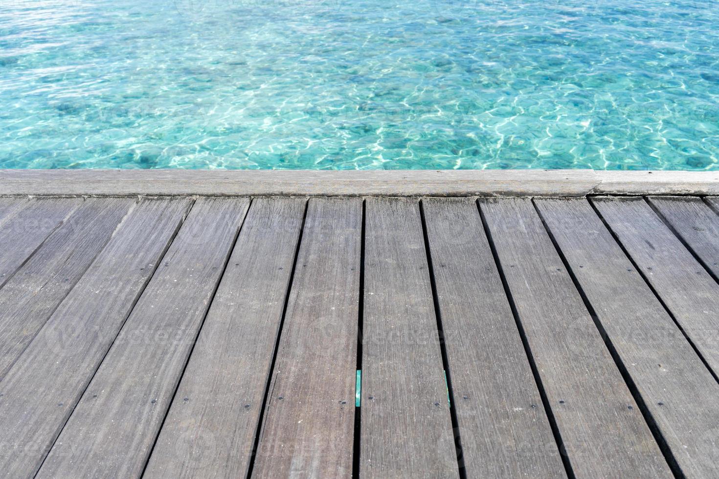 Wooden floor with seascape background photo