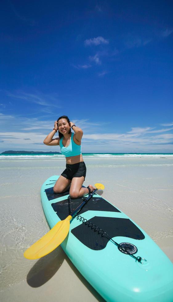 woman on sup board at the beach photo