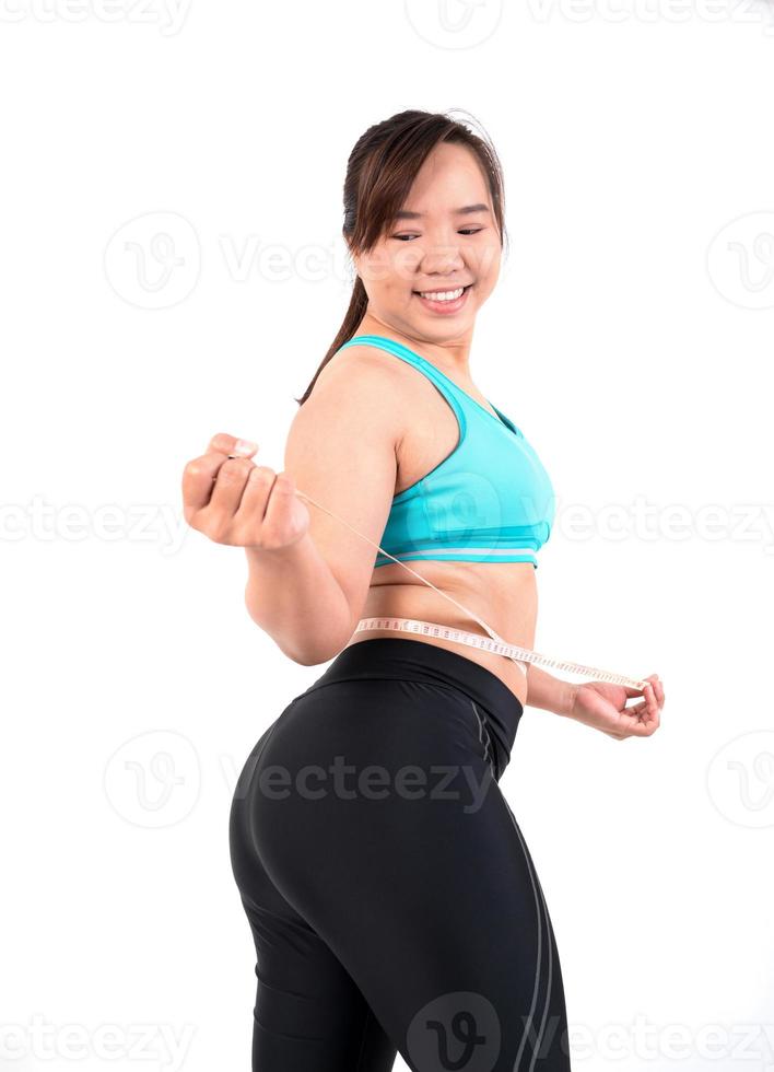 chubby  woman measuring her waistline photo