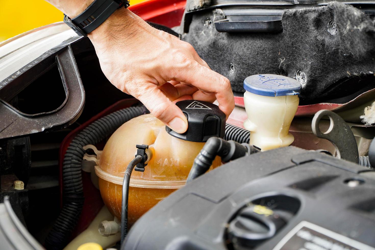 Asian technicians inspect radiator water for engine compartment maintenance and basic vehicle and brake service concepts. photo