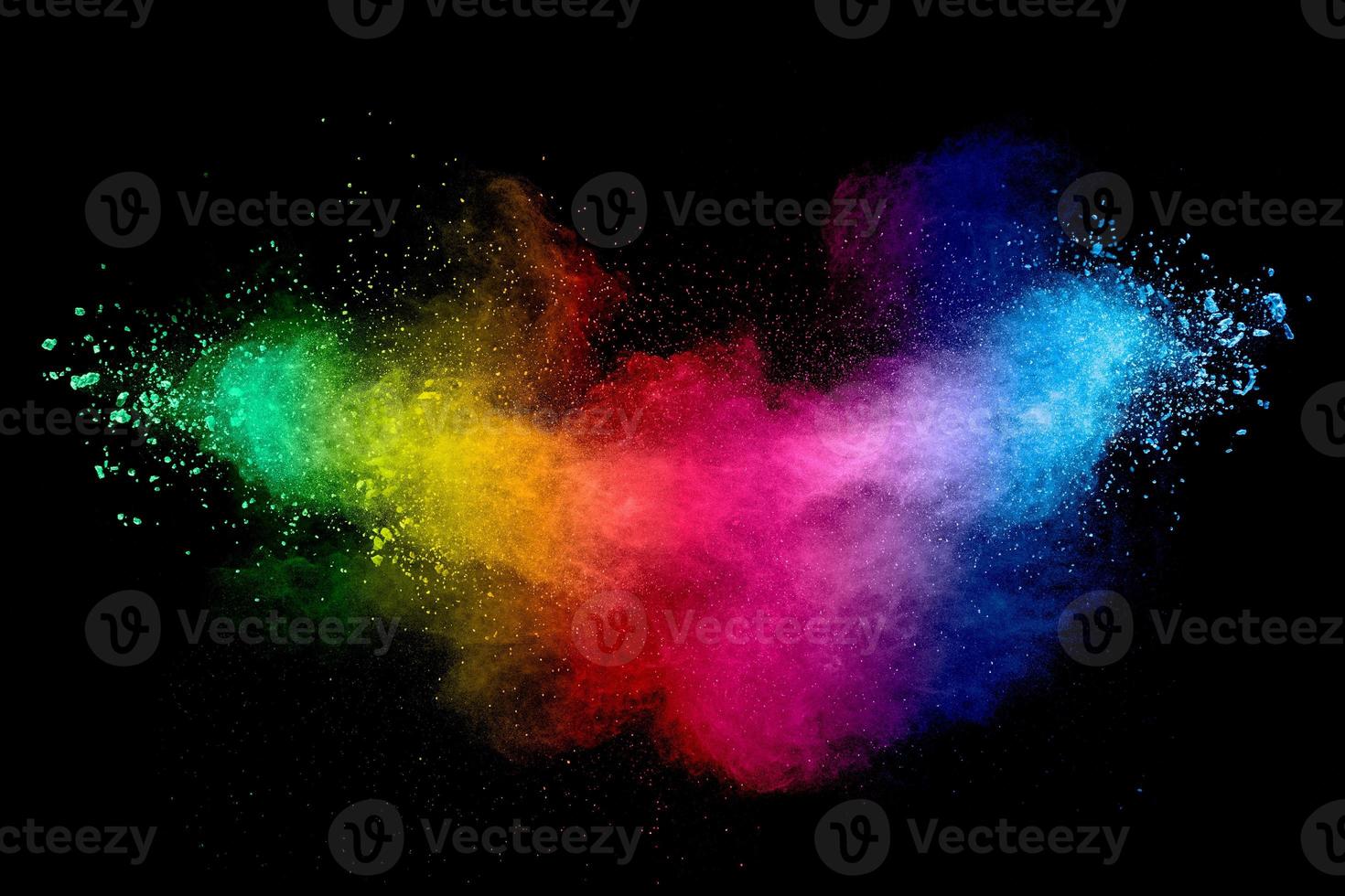 Colorful background of pastel powder explosion.Rainbow color dust splash on black background. photo