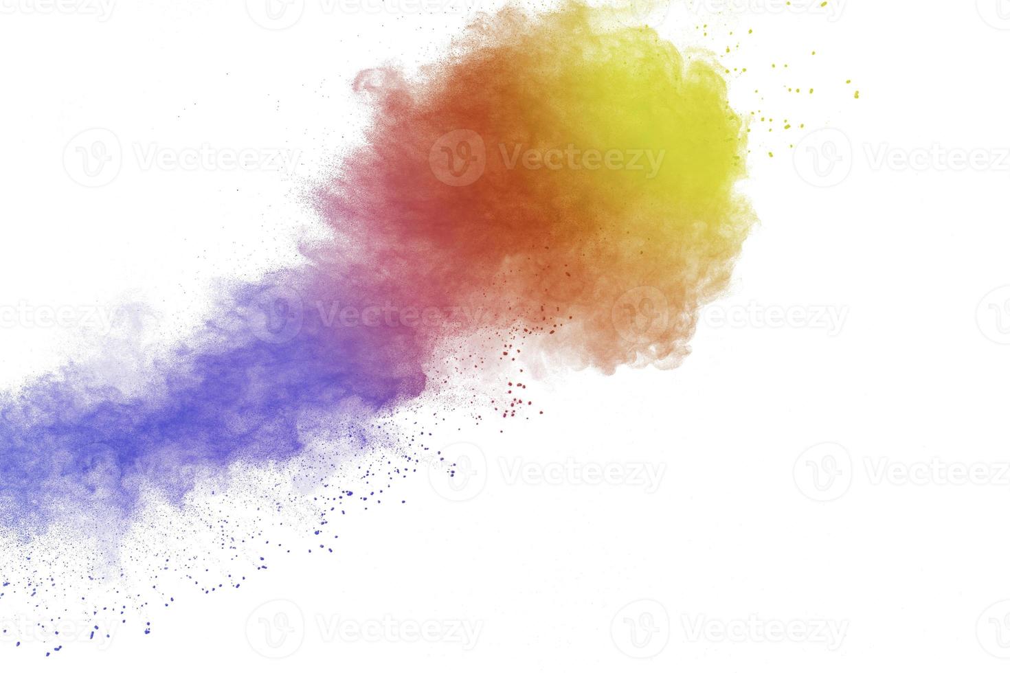 Abstract multi colored powder explosion on white background. Freeze motion of colorful dust  particle splash. photo