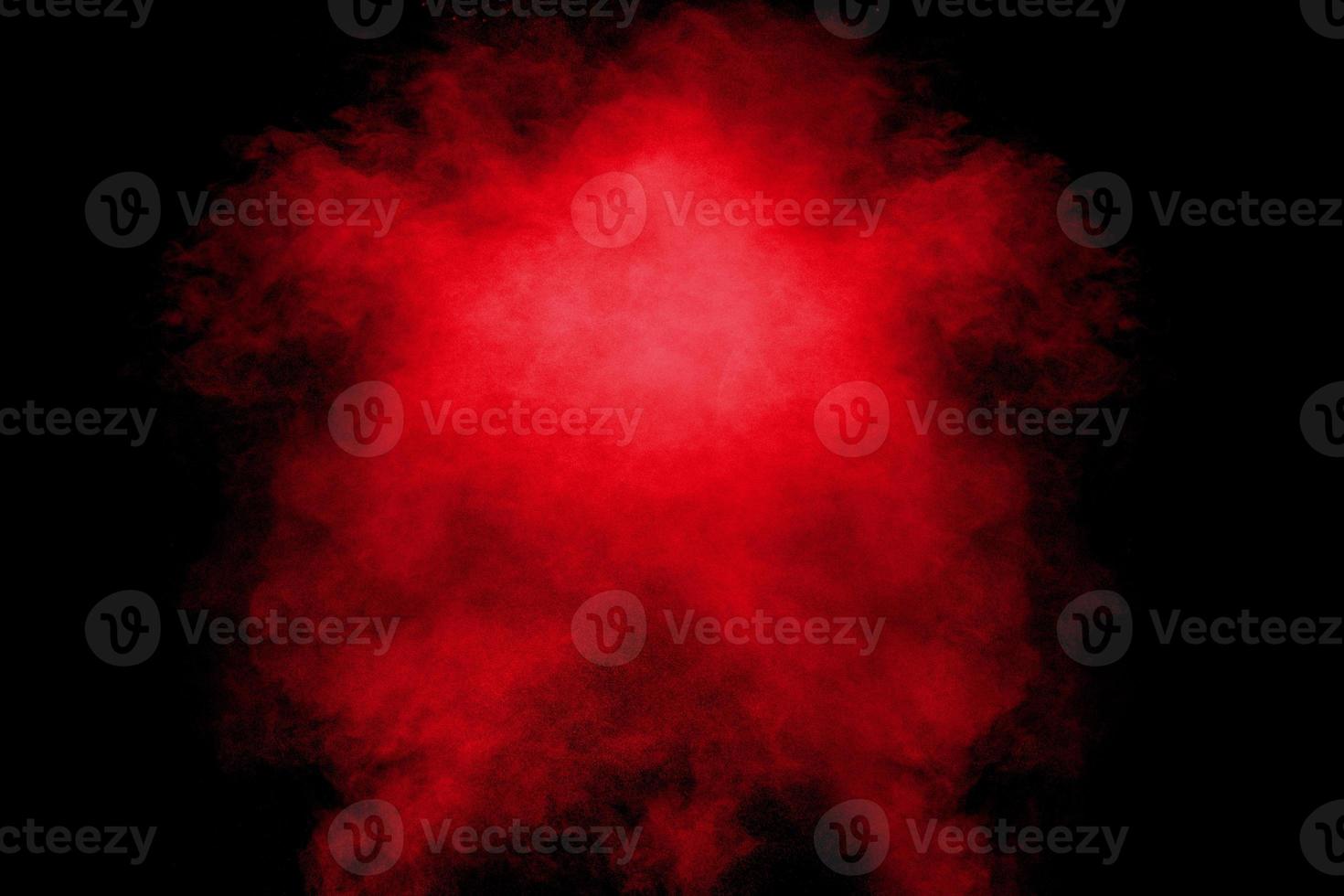 Red orange color powder explosion cloud  on black background. photo