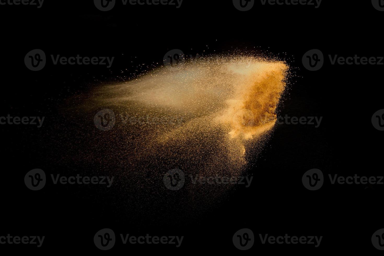 Dry river sand explosion isolated on black background. Abstract sand cloud.Brown colored sand splash against dark background. photo