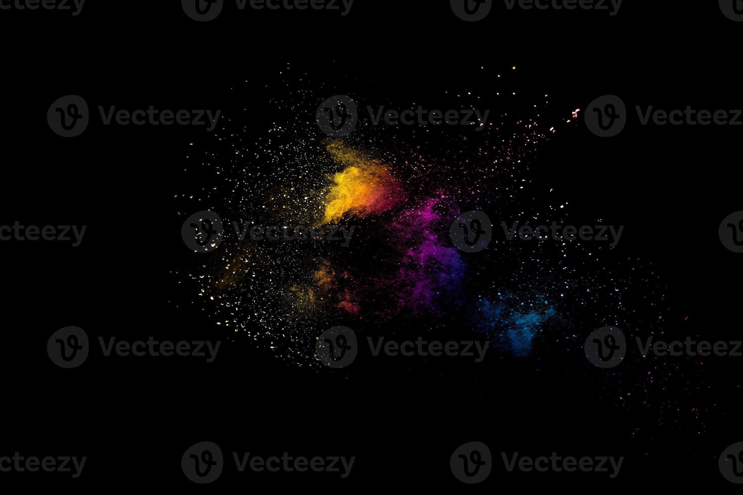 Launched multicolored powder on black background.Color powder explosion.Colorful dust splashing. photo