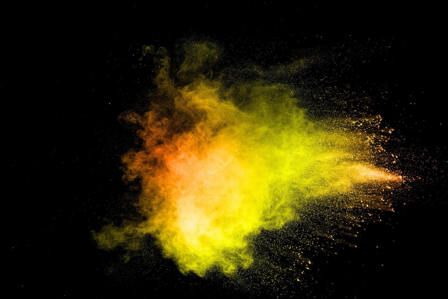 The explosion of colorful pigment powder on black background. Vibrant color dust particles textured background. photo