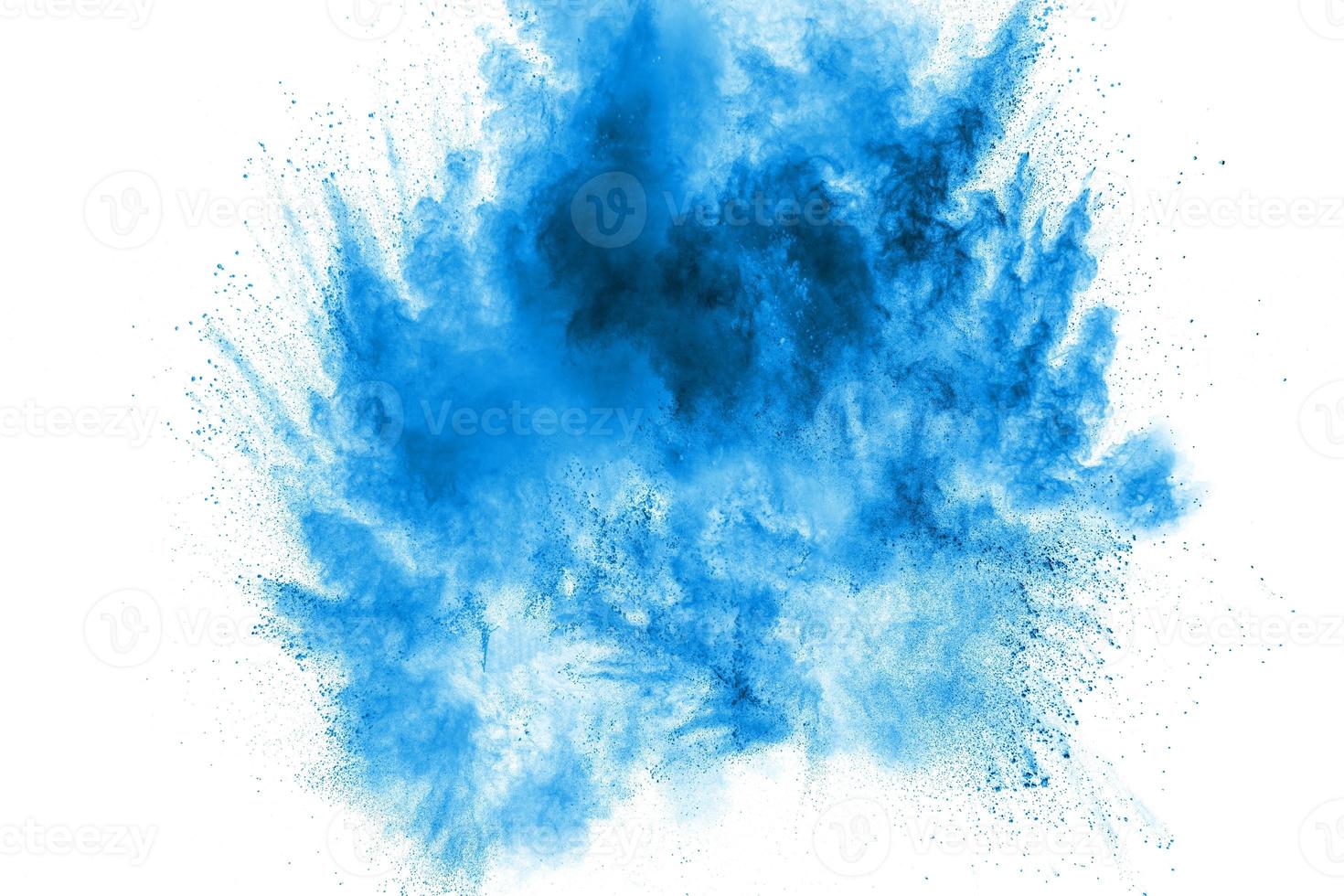 Bizarre forms of blue powder explode cloud on white background. Launched blue dust particles splashing. photo