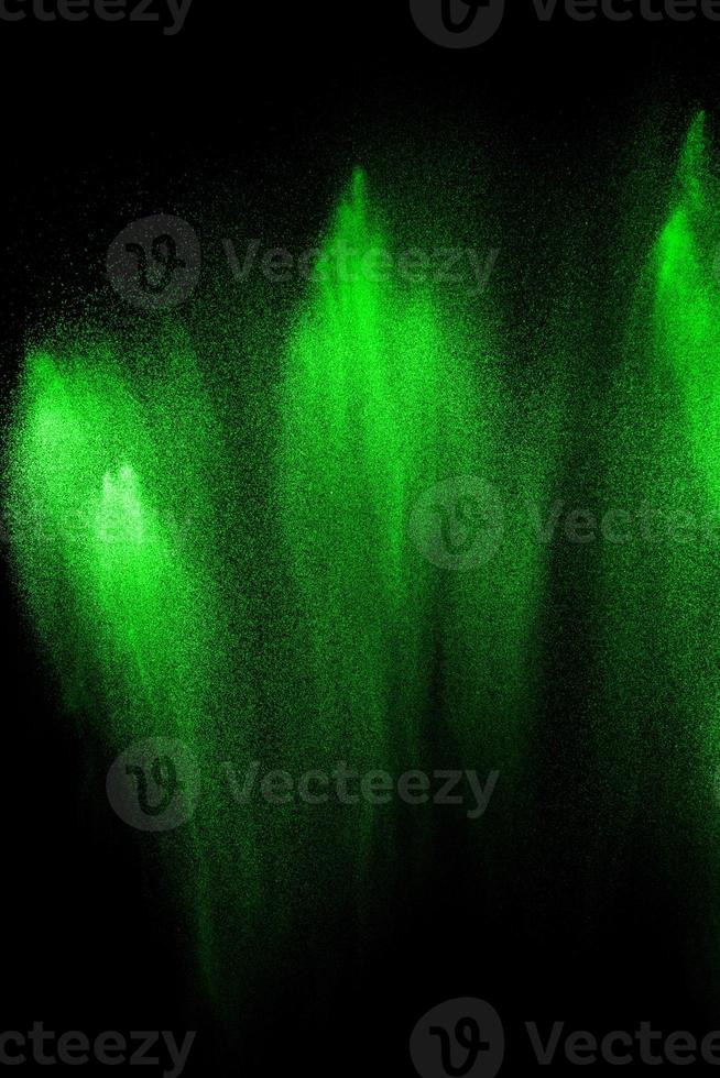 Green particles explosion on black background. Color dust splash use for abstract background. photo