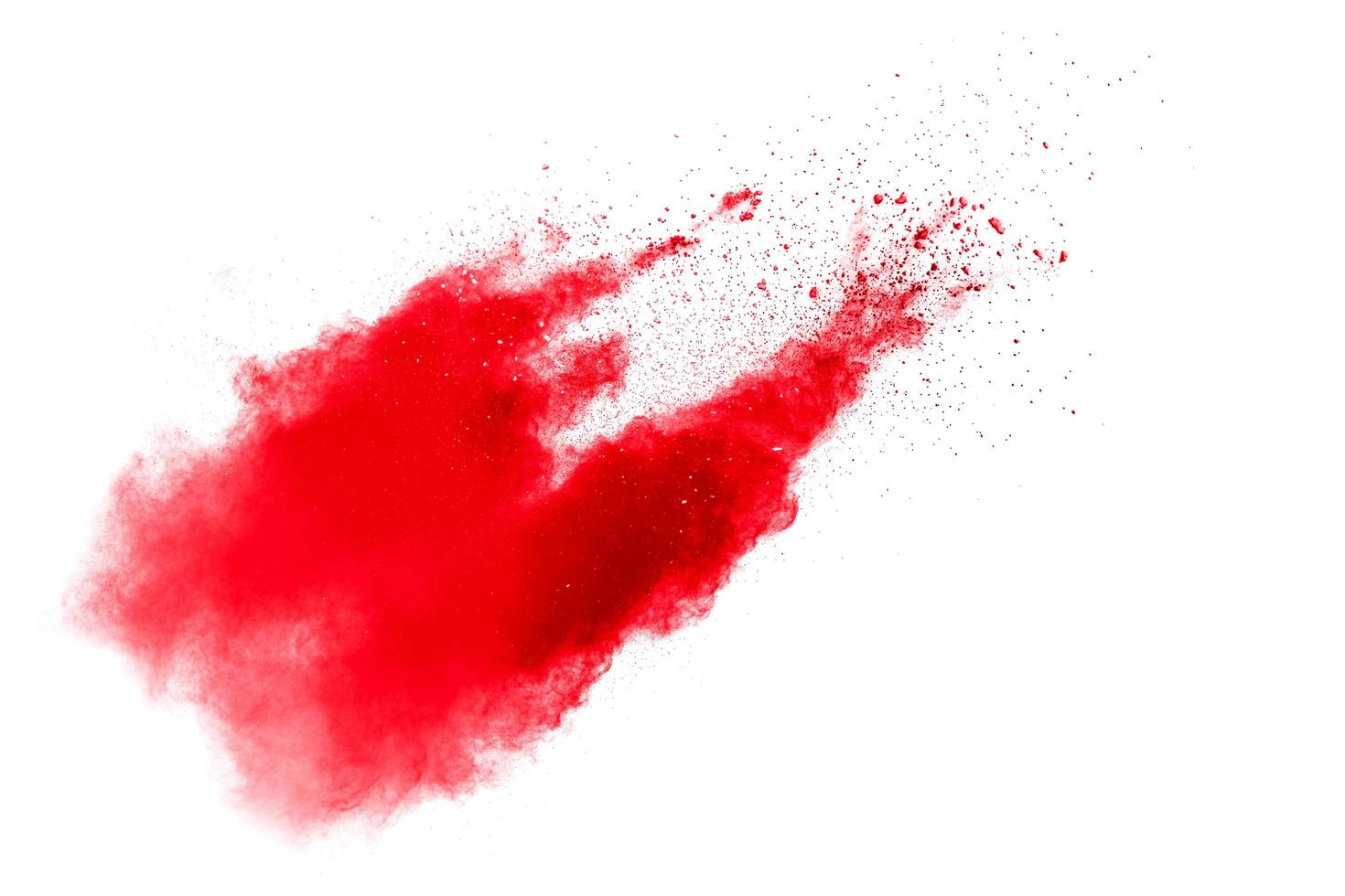 Abstract red dust splattered on white background. Red powder explosion.Freeze motion of red particles splashing. photo