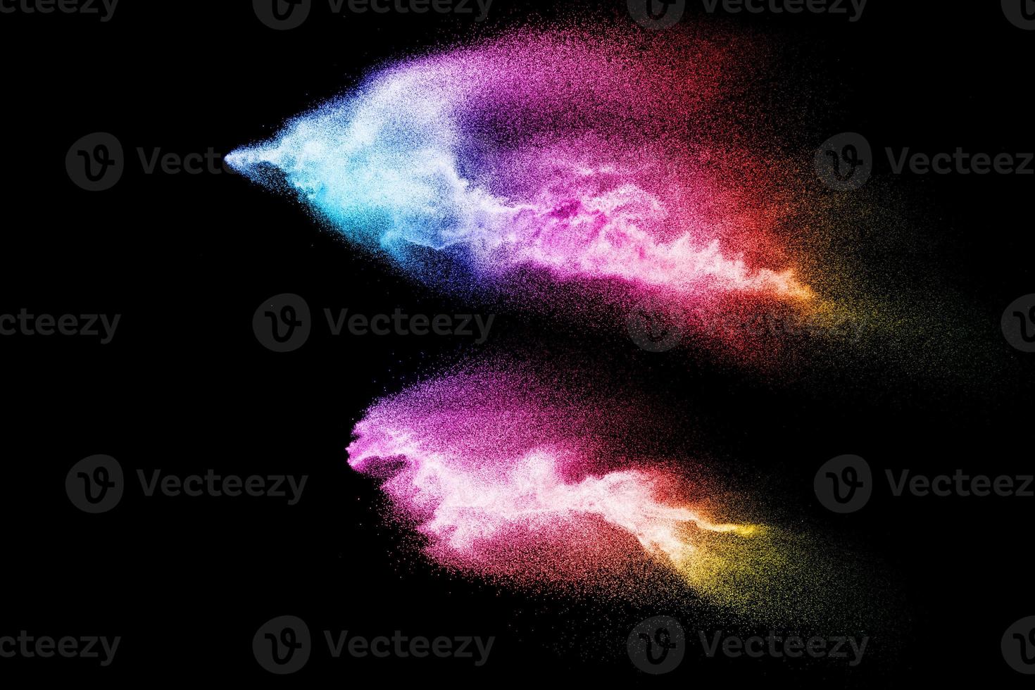 Abstract multicolored sand explosion isolated on black background. Abstract sand cloud. Sandy fly wave in the air. photo