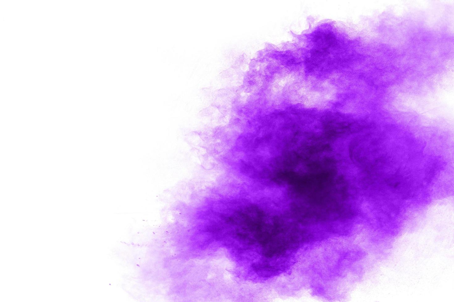 Abstract purple powder explosion on white background, Freeze motion of purple dust splashing. photo