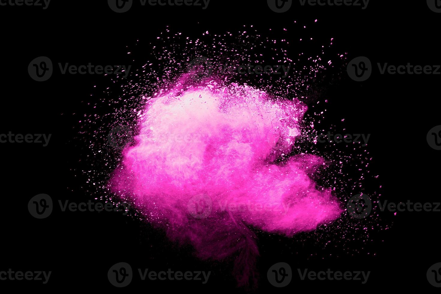 Pink powder explosion.Pink dust splash cloud on dark background. photo