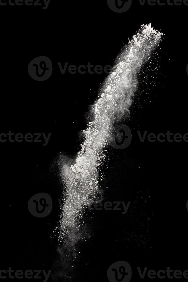 White powder explosion cloud against black background.White dust particles splash. photo