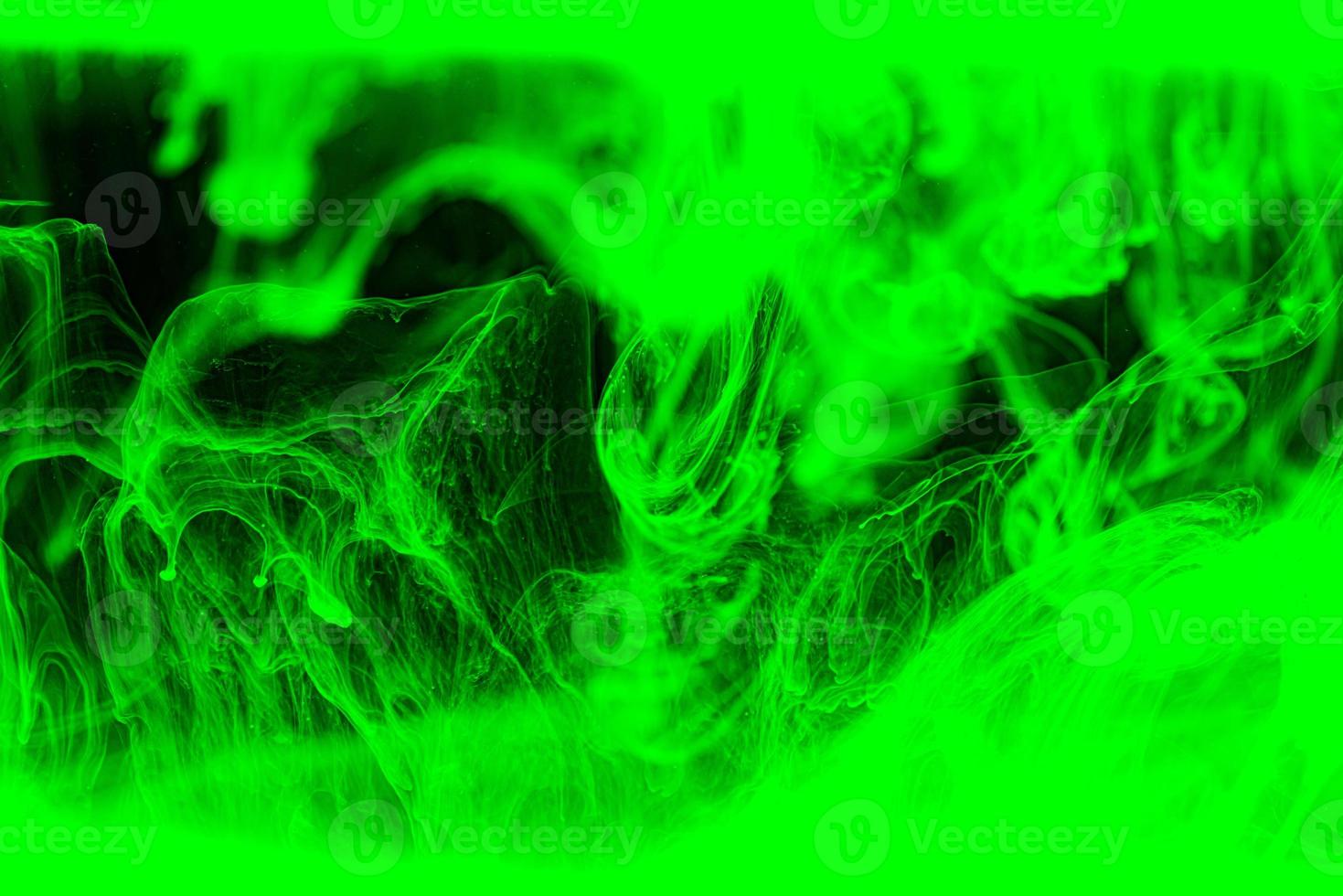 Abstract green acrylic ink background. Dramatic green wave in black. photo