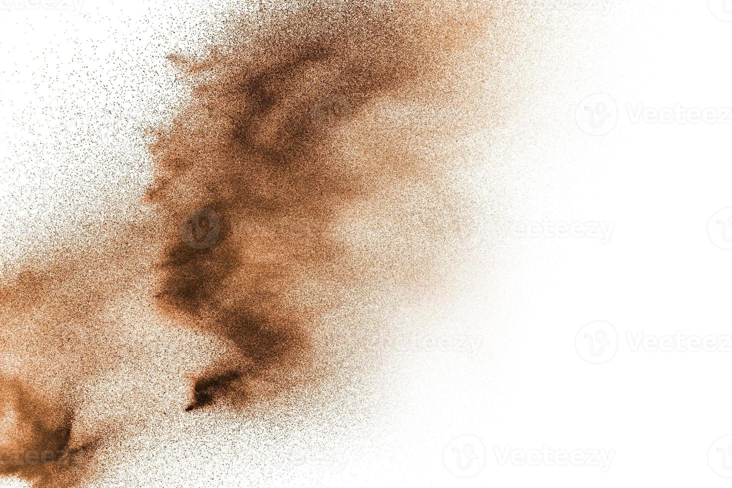 Dry river sand explosion. Brown color sand splash against white background. photo
