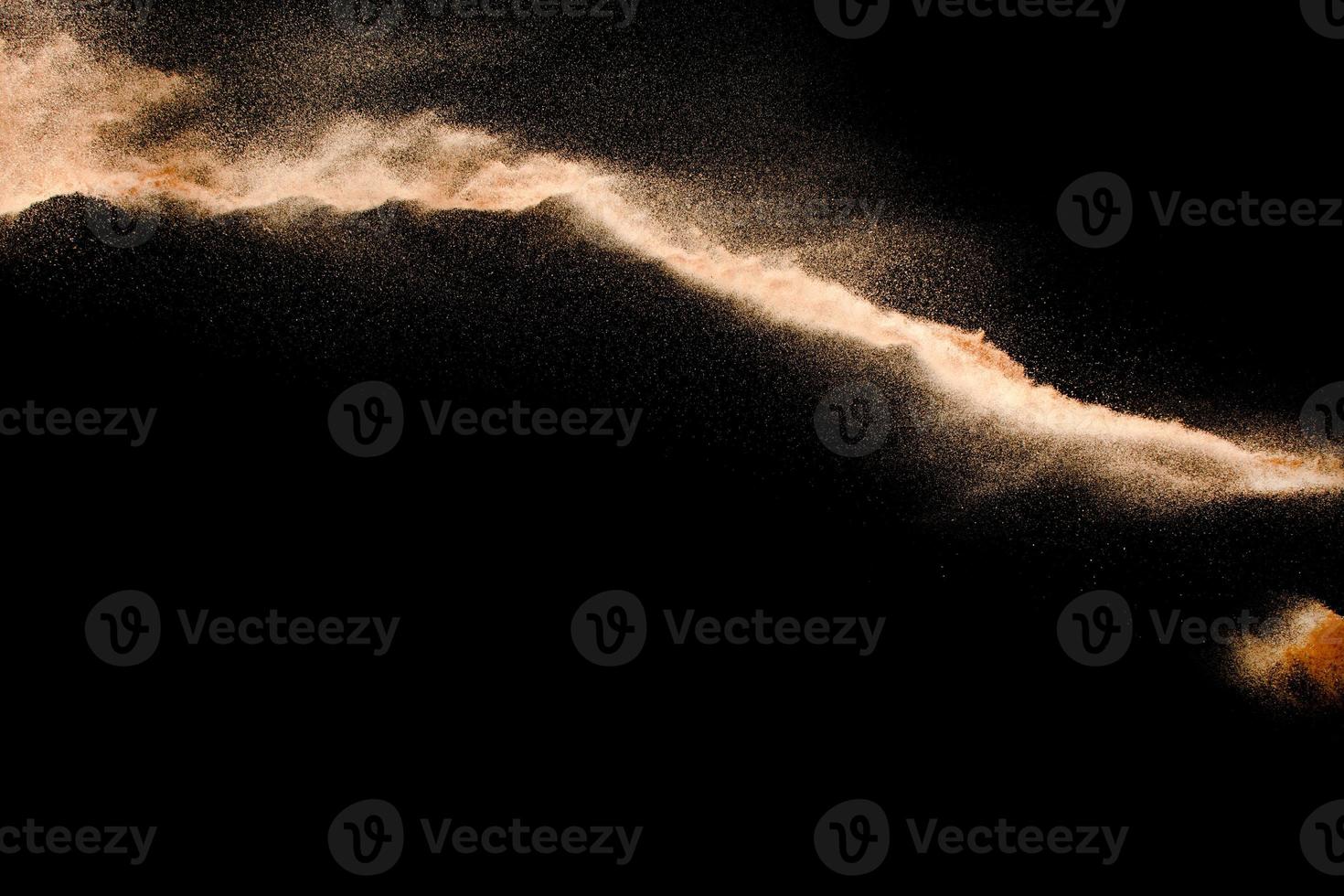 Dry river sand explosion isolated on black background. Abstract sand cloud.Brown colored sand splash against dark background. photo