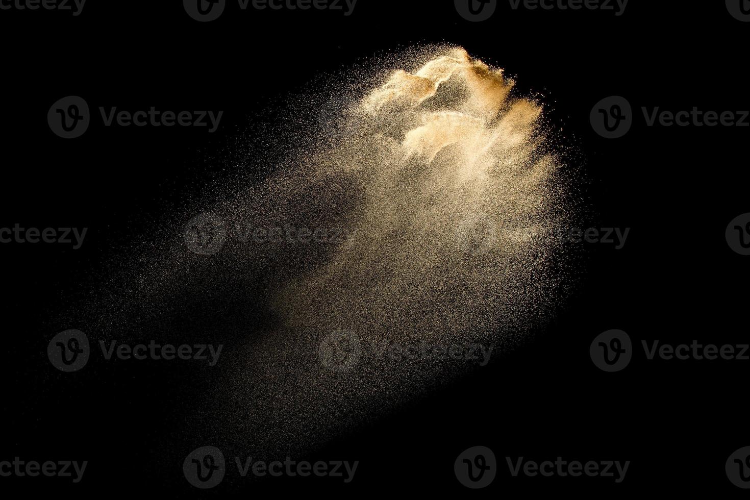 explosión de arena de río seco aislada sobre fondo negro. nube de arena abstracta. salpicadura de arena de color marrón sobre fondo oscuro. foto