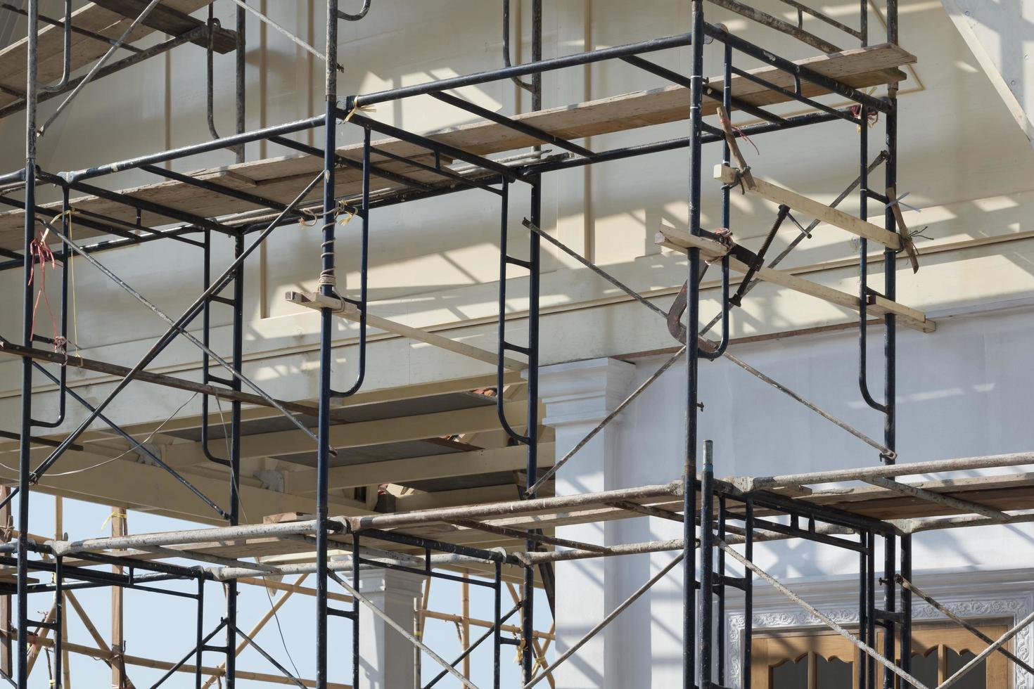 Side view of empty scaffolding outside of renovation house construction site area photo