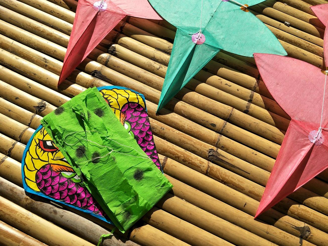 star-shaped kites and snake kite on wooden litter with light and shadow in Thai art of craft concept photo