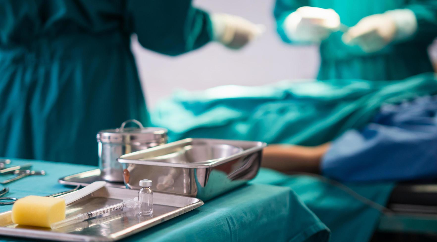 Surgical instruments and tools including scalpels, forceps and tweezers arranged on a table for a surgery, operating room with surgery equipment, preparing medical instruments for operation photo