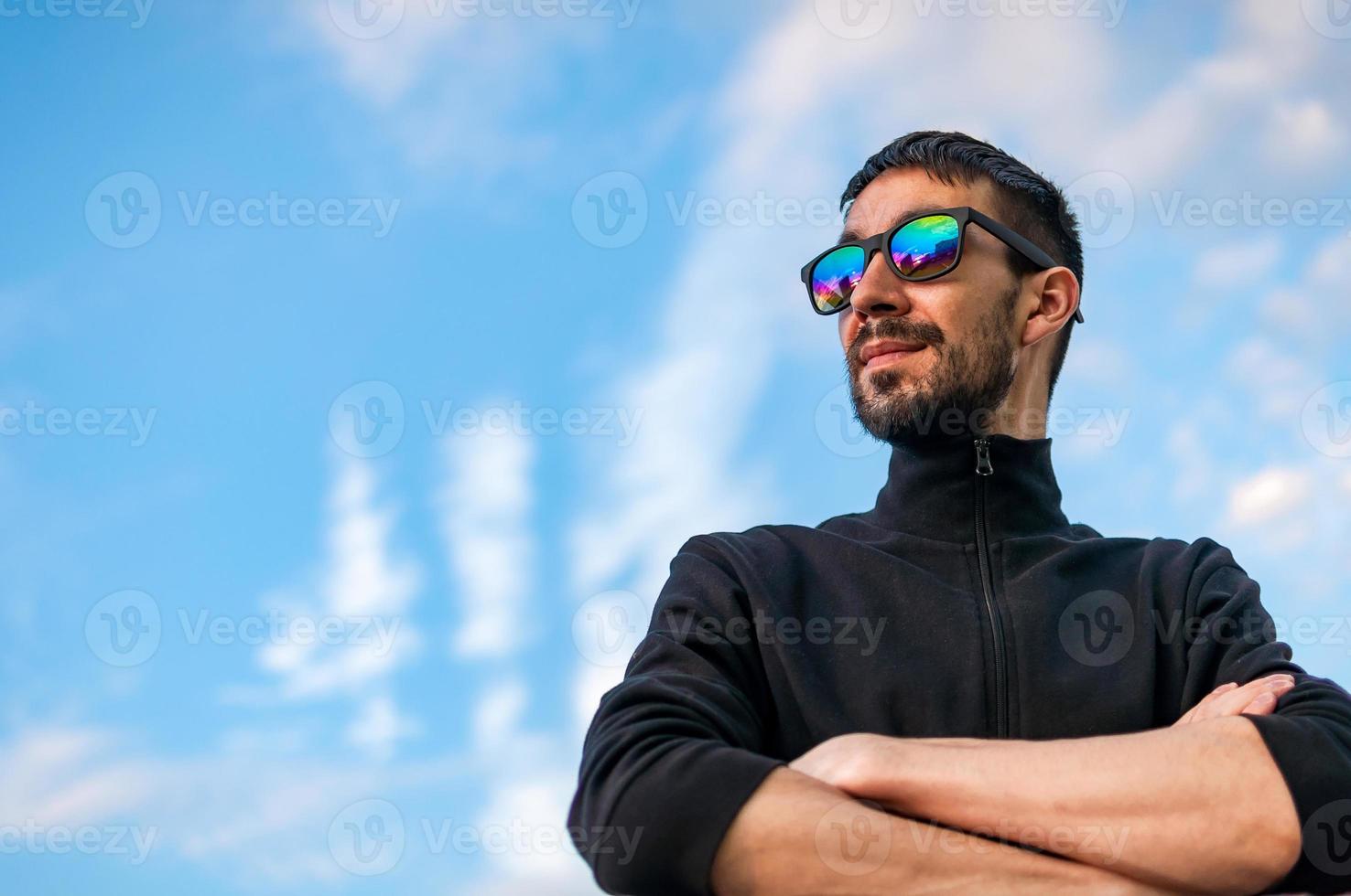 Portrait of a young man with glasses on the street photo