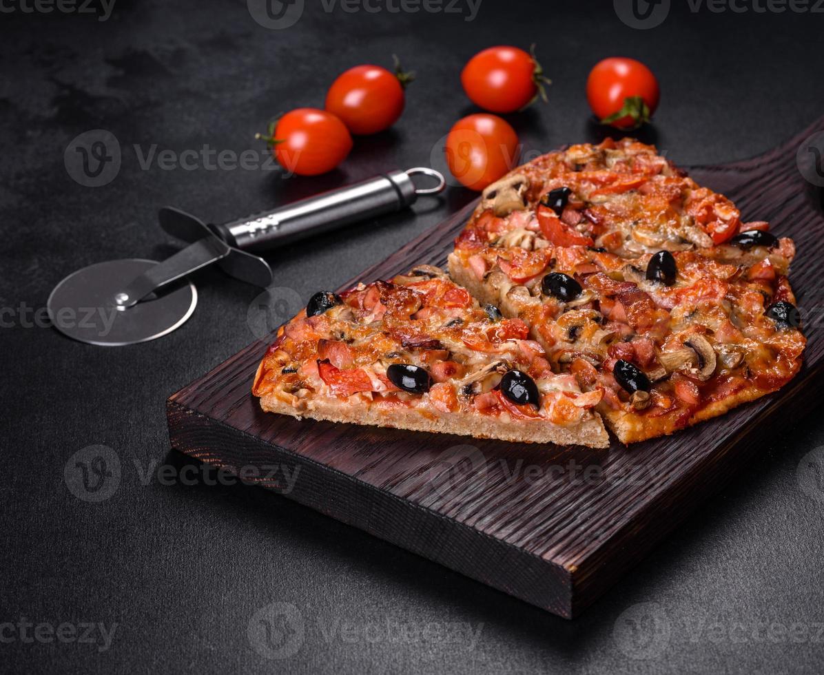 Homemade vegetable pizza with addition of tomatoes, olives and herbs photo