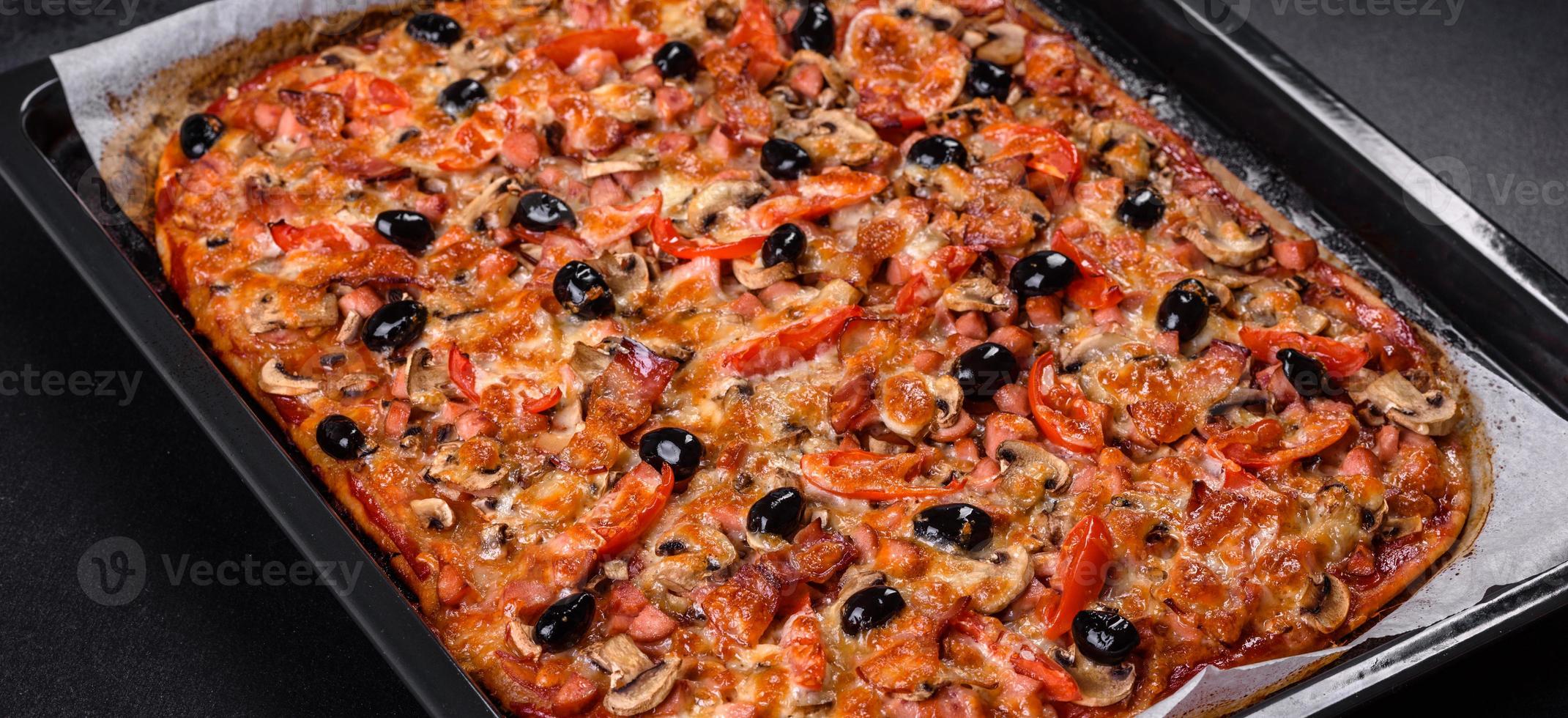 Homemade vegetable pizza with addition of tomatoes, olives and herbs photo