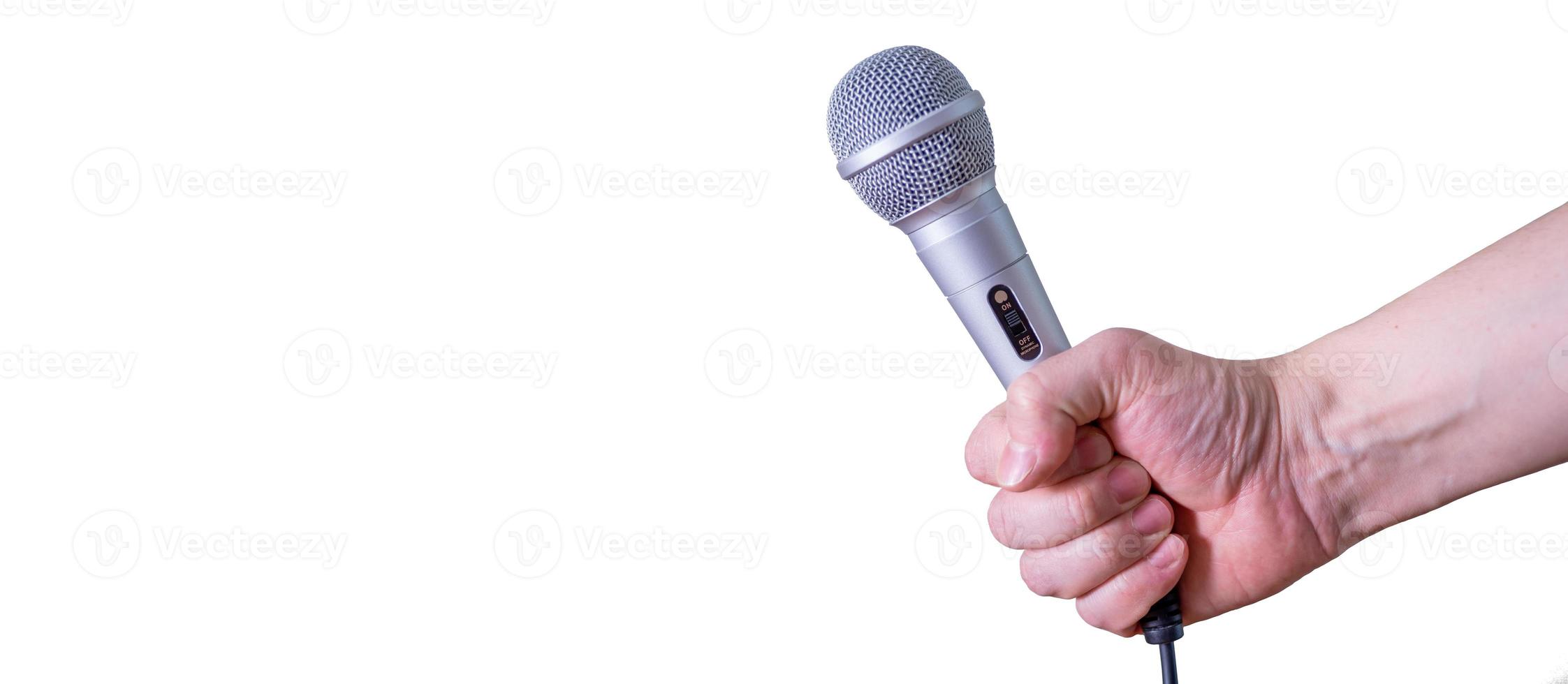 Female hand with microphone, on white background. photo