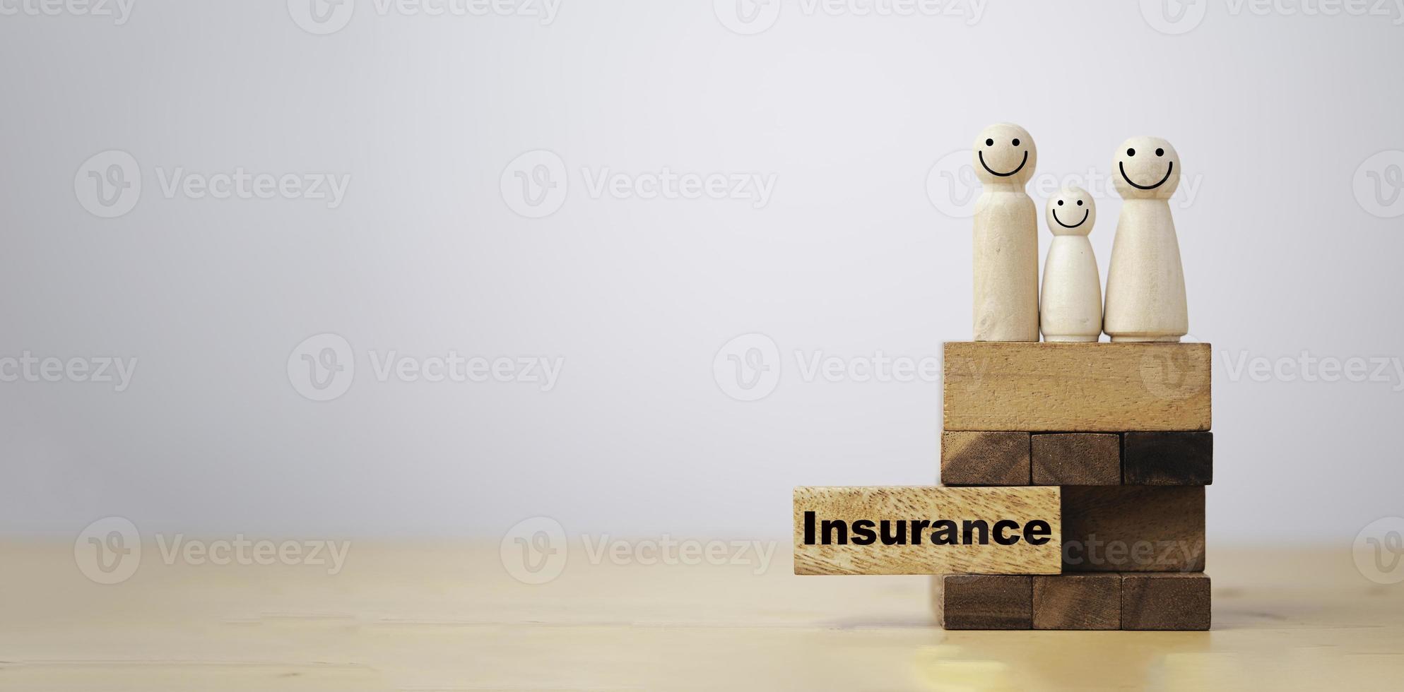 Pull out wooden block which print screen insurance wording with wooden human on top for family insurance to make life security concept. photo