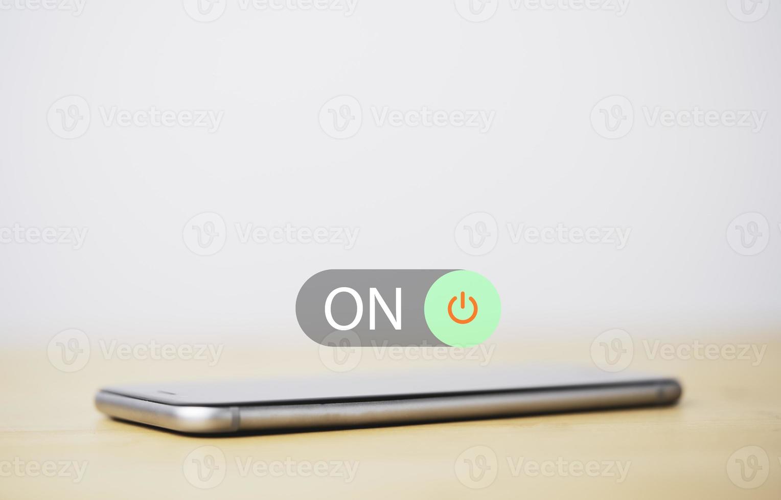 Smartphone with toggle switch button for change from off to on status. photo