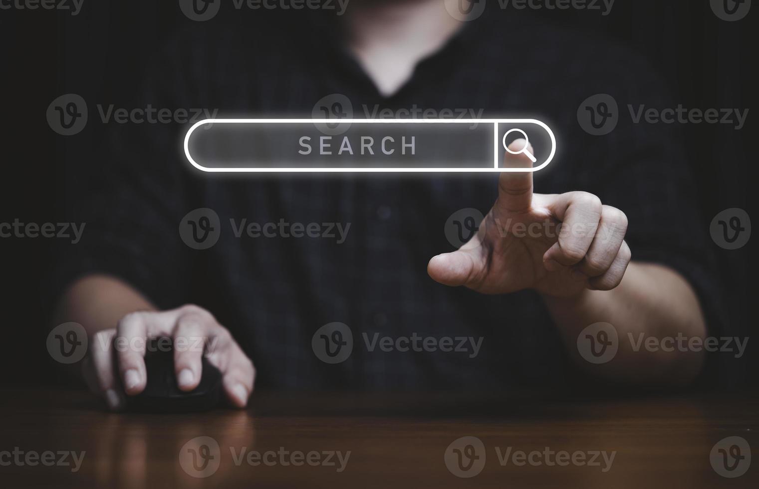 Hand touching to virtual search icon to SEO or search Engine Optimisation for marketing and consumer information concept. photo