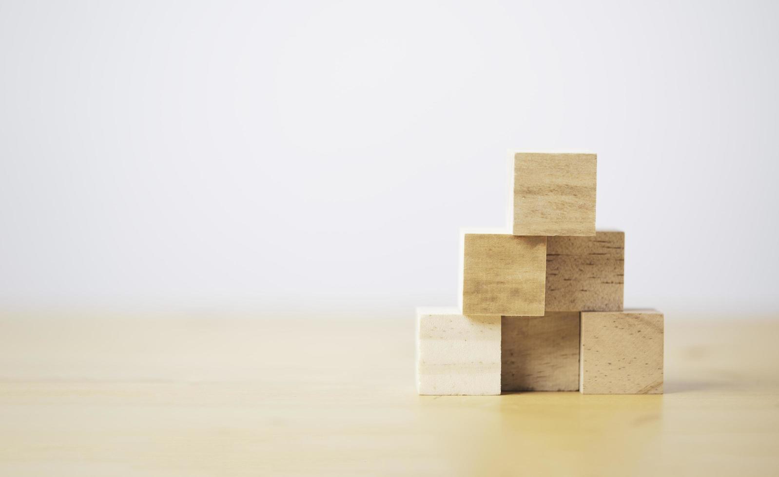 Stacking blank wooden cubes on table with copy space for input wording and infographic icon. photo