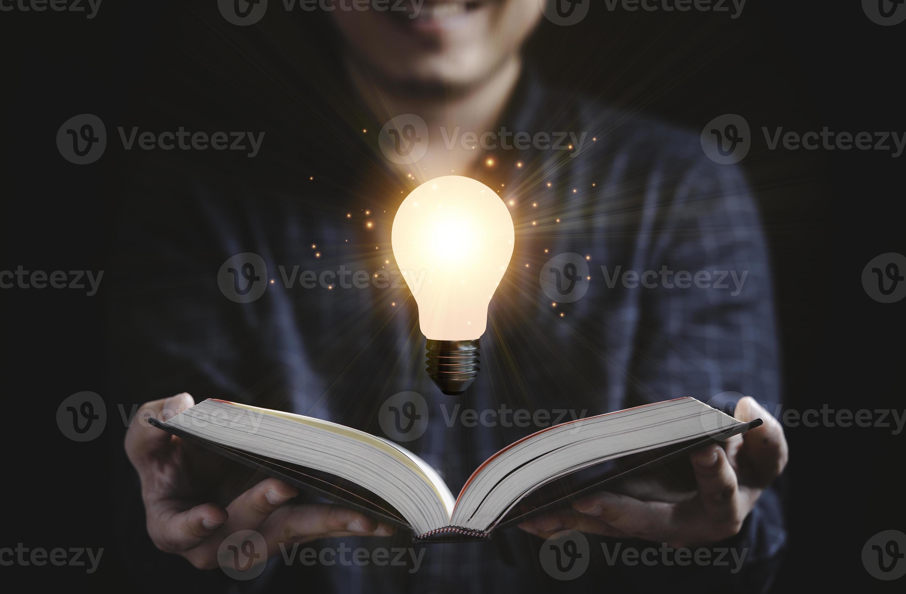 Reader open book with floating glowing light bulb for reading education
