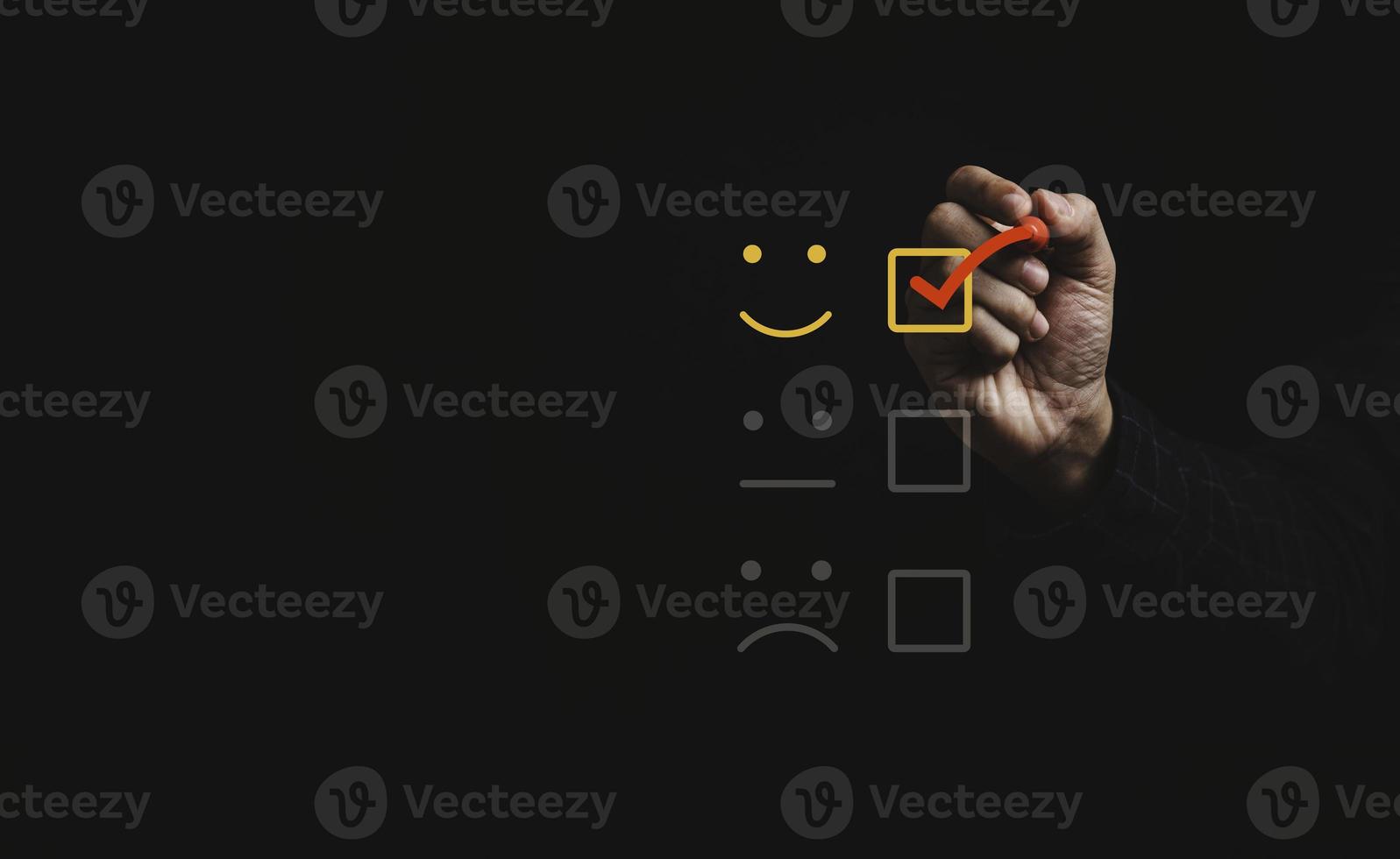 Businessman tick mark to select smile button for the best evaluation , customer satisfaction concept. photo