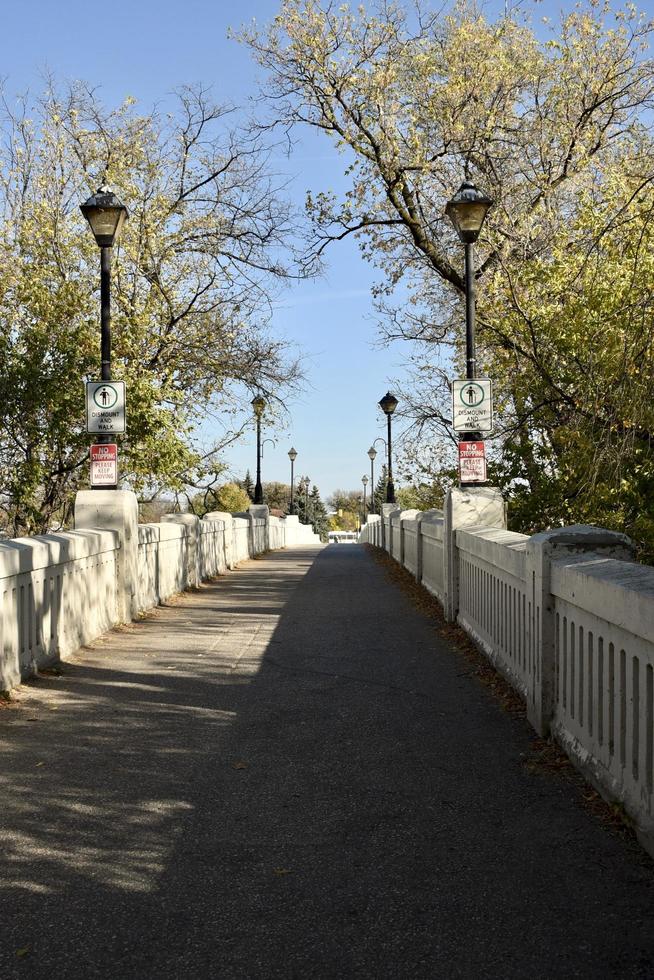 a foot bridge into a park photo