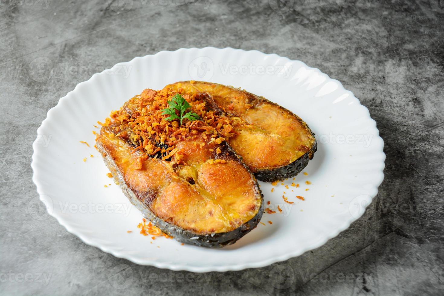 Deep Fried Pangasius fish with Black Pepper Garlic and fish source, quick and easy dish. photo
