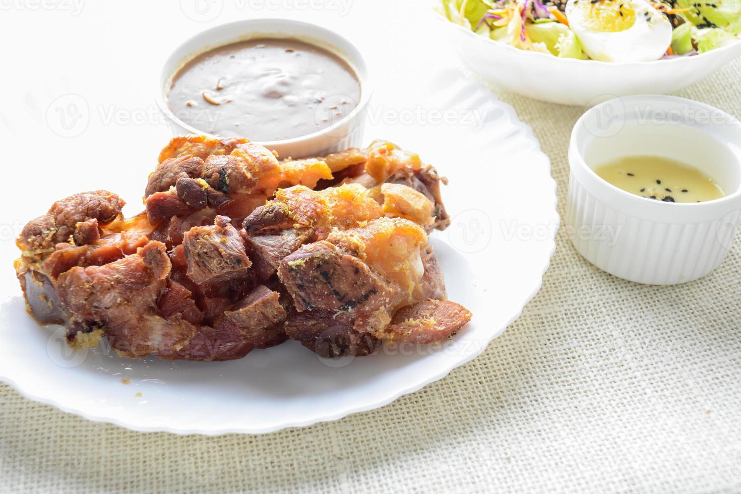 Deep fried pork knuckle with mushroom gravy source, fresh vegetable and salad cream source photo