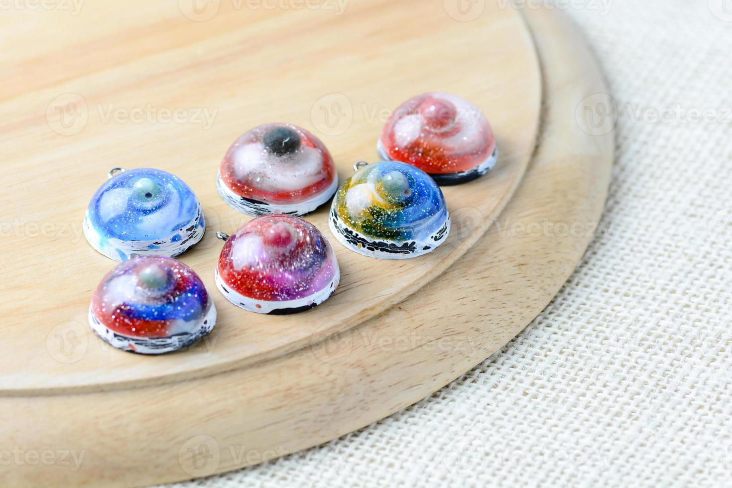 Create galaxy drink coasters using resin, glitter and pigment powders, handmade items. Suitable for keychains, necklace and pendant. photo