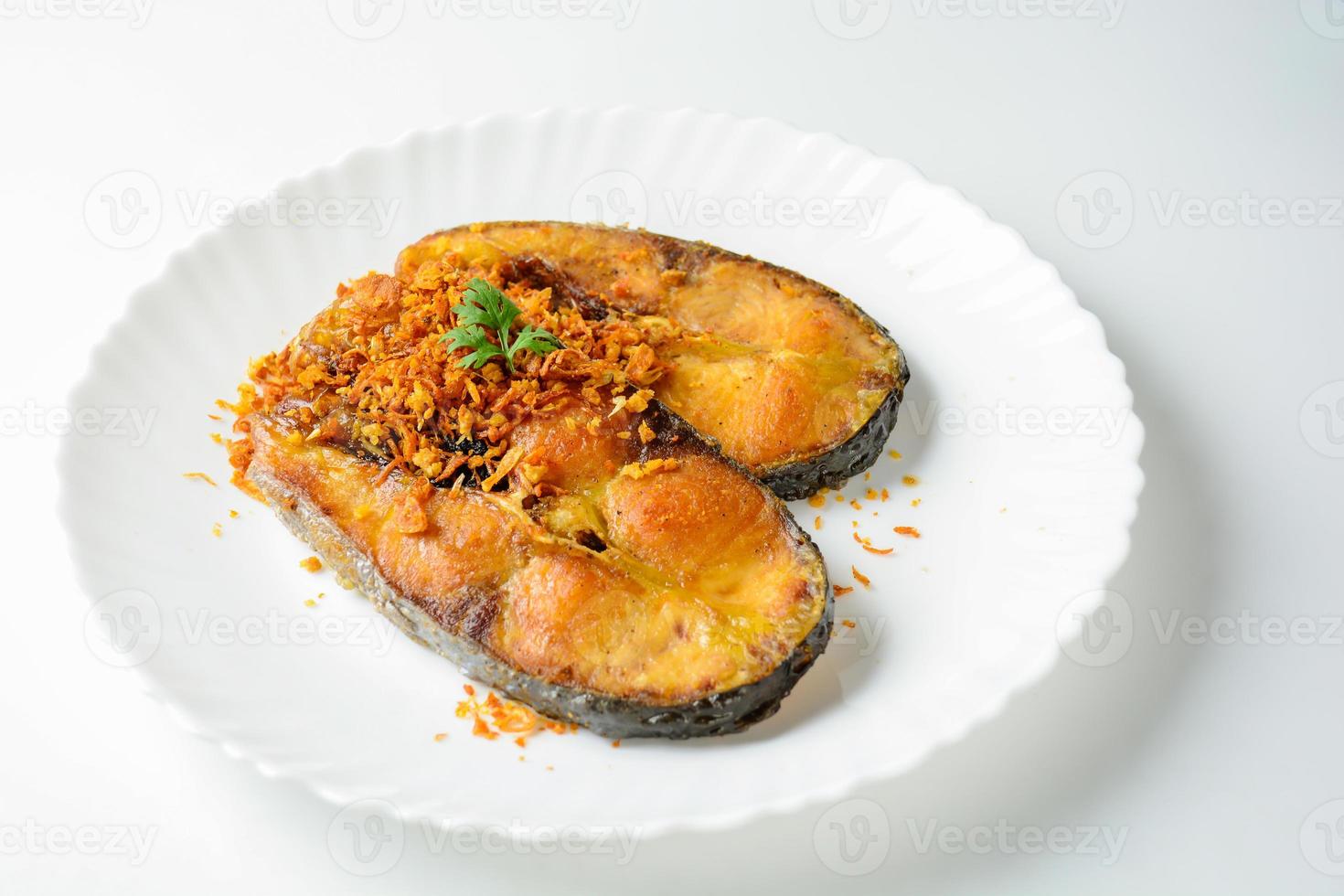 Deep Fried Pangasius fish with Black Pepper Garlic and fish source, quick and easy dish. photo