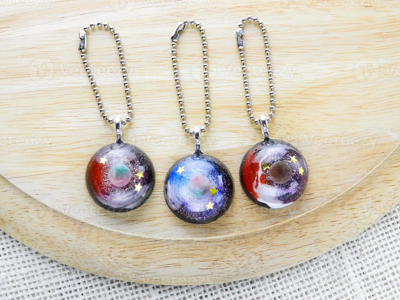 Create galaxy drink coasters using resin, glitter and pigment powders, handmade items. Suitable for keychains, necklace and pendant. photo