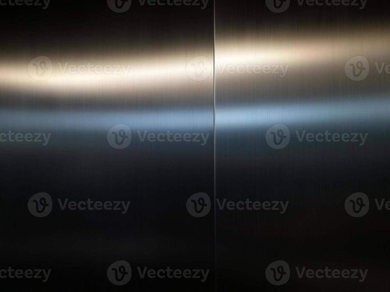 Stainless steel large sheet  With light hitting the surface  For background,Inside passenger elevator,Reflection of light on a shiny metal texture,stainless steel background. photo