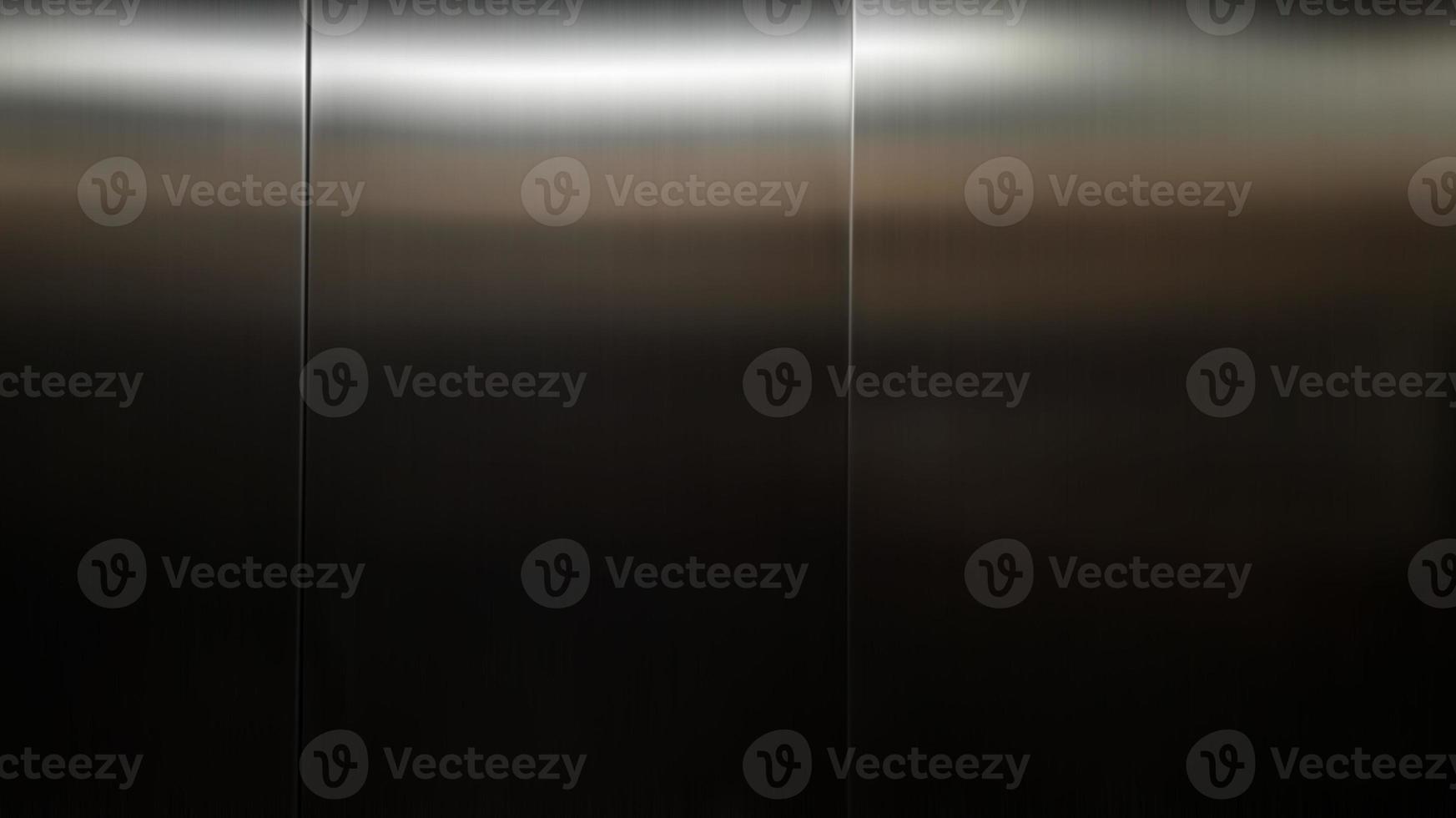 Stainless steel large sheet  With light hitting the surface  For background,Inside passenger elevator,Reflection of light on a shiny metal texture,stainless steel background. photo