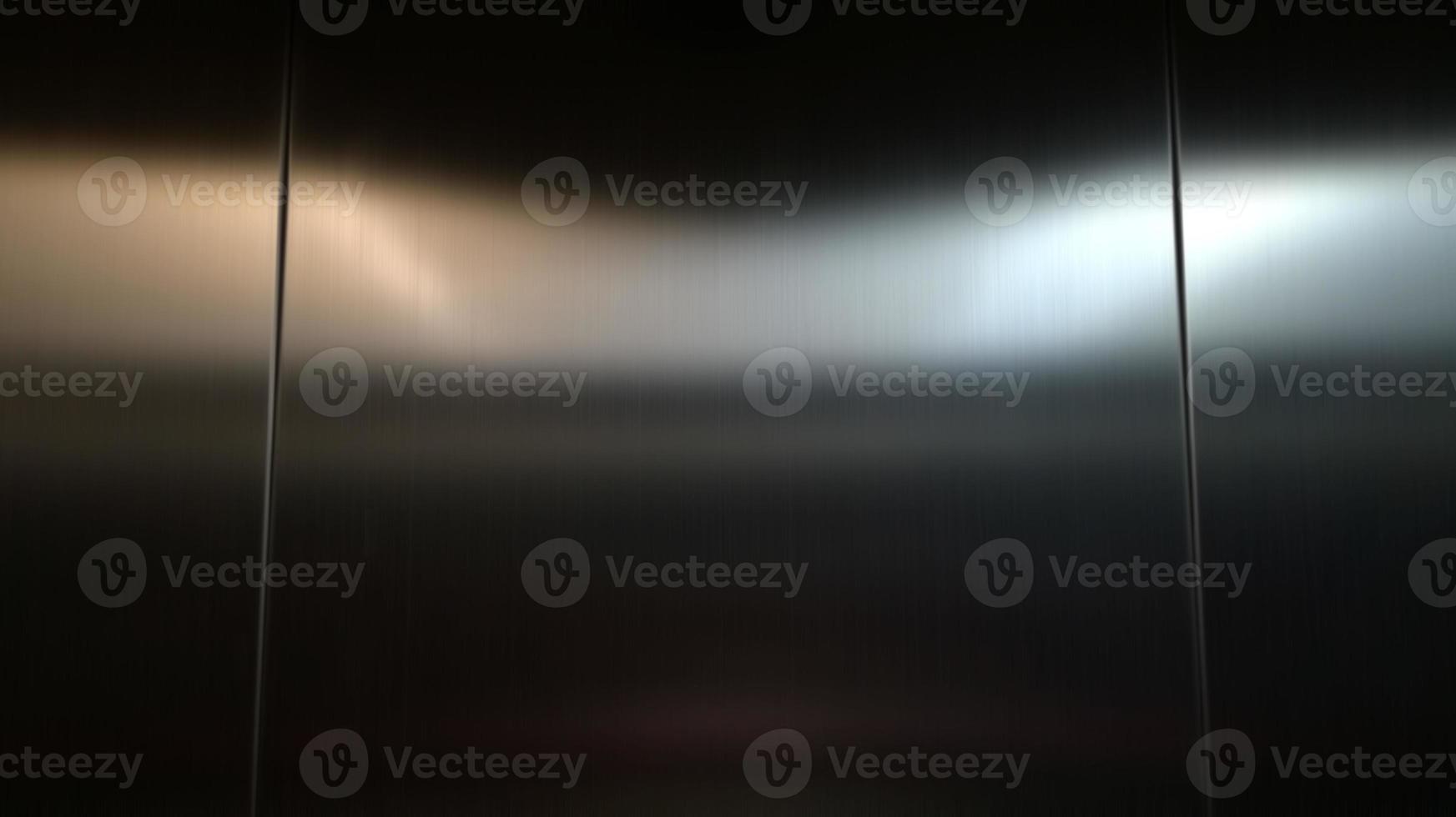 Stainless steel large sheet  With light hitting the surface  For background,Inside passenger elevator,Reflection of light on a shiny metal texture,stainless steel background. photo