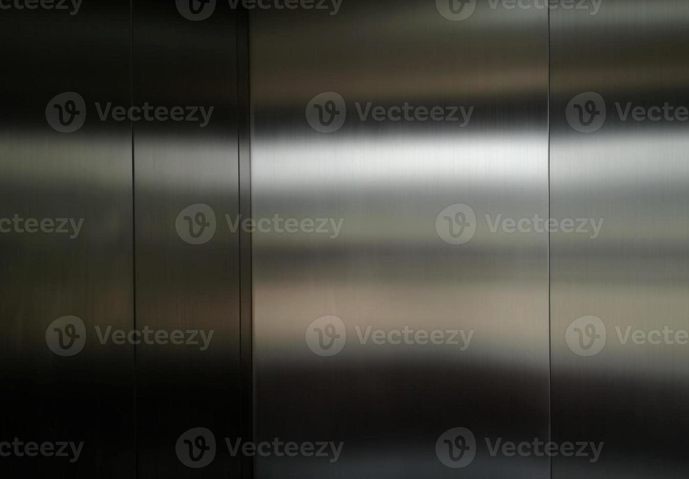 Stainless steel large sheet  With light hitting the surface  For background,Inside passenger elevator,Reflection of light on a shiny metal texture,stainless steel background. photo