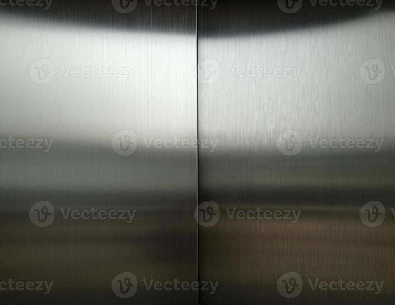 Stainless steel large sheet  With light hitting the surface  For background,Inside passenger elevator,Reflection of light on a shiny metal texture,stainless steel background. photo