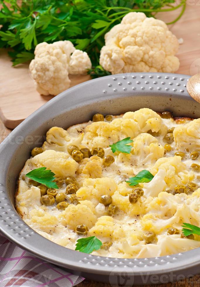 cauliflower baked with egg and cheese with green peas photo