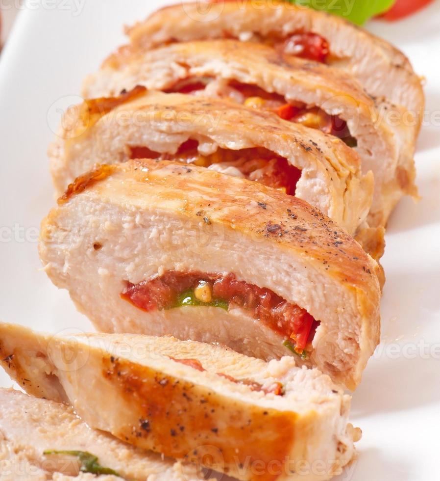 Grilled chicken breast stuffed with basil, tomato and garlic photo