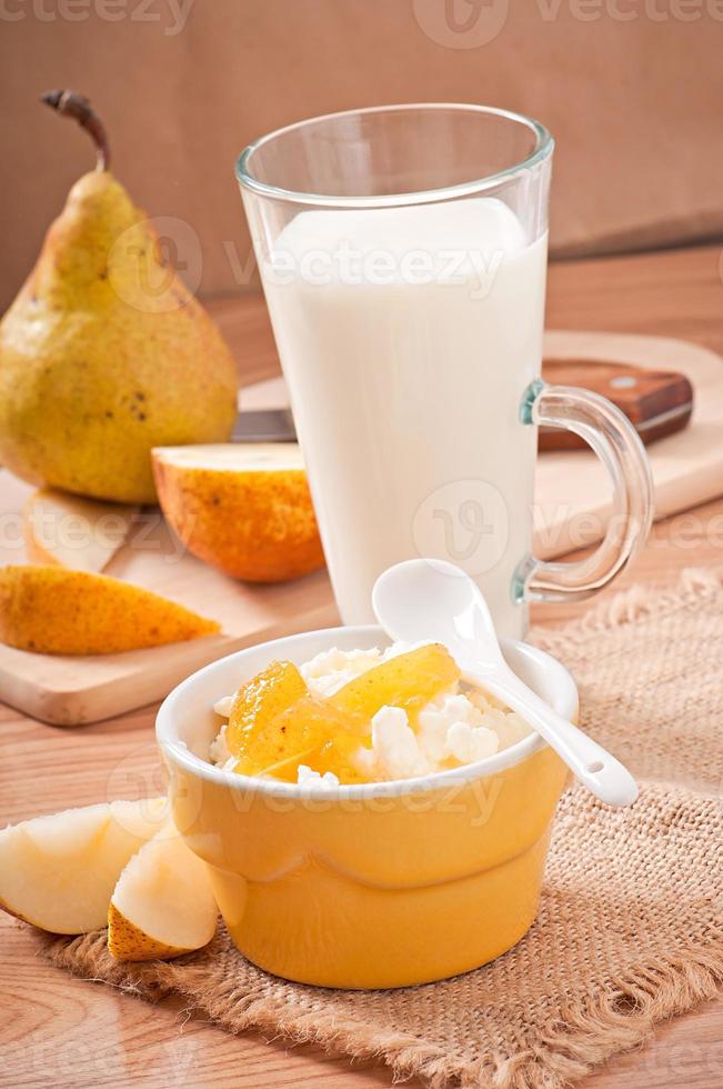 cottage cheese in bowl with pear jam and a glass of milk photo